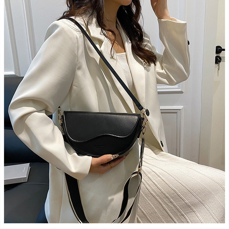 The Wave Silhouette Asymmetric Leather Saddle Bag
