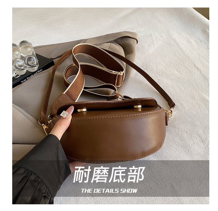 The Wave Silhouette Asymmetric Leather Saddle Bag