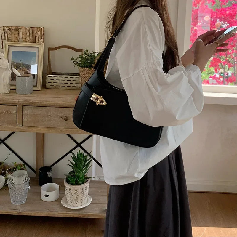 Minimalist Crescent Shoulder Bag with Buckle Accent and Adjustable Strap