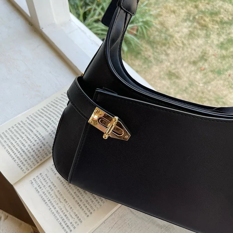 Minimalist Crescent Shoulder Bag with Buckle Accent and Adjustable Strap