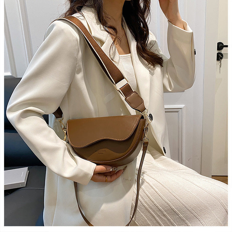 The Wave Silhouette Asymmetric Leather Saddle Bag
