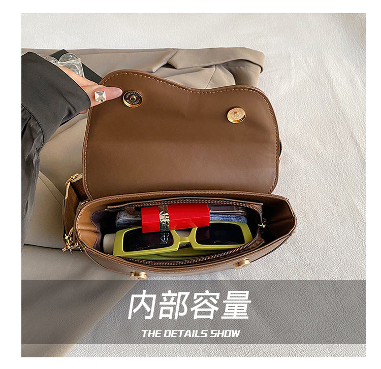 The Wave Silhouette Asymmetric Leather Saddle Bag