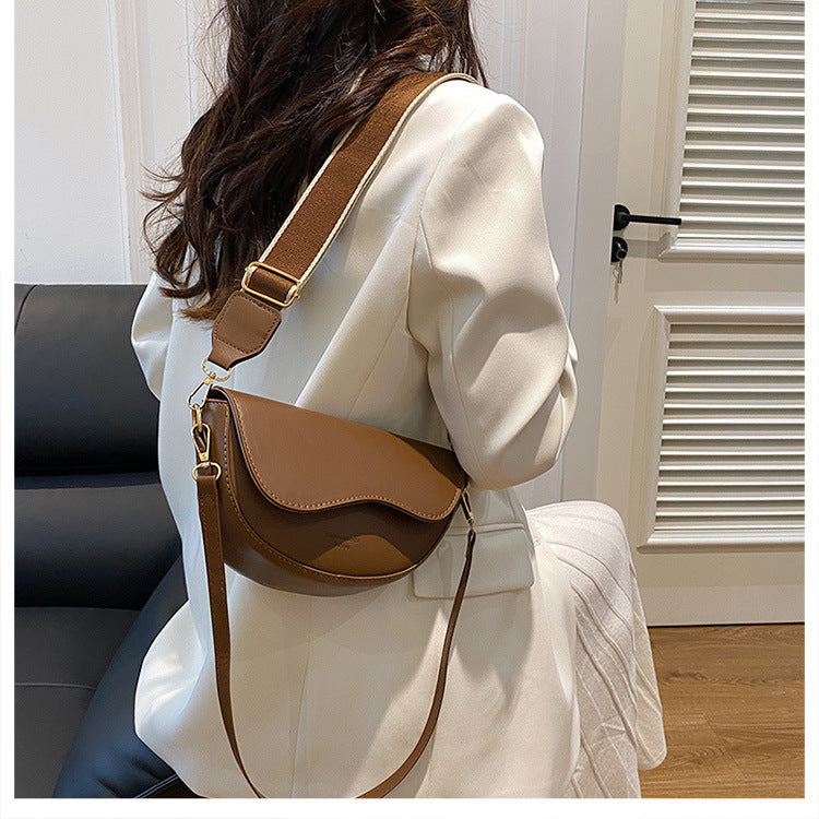 The Wave Silhouette Asymmetric Leather Saddle Bag