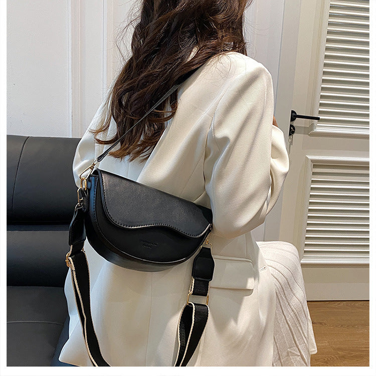 The Wave Silhouette Asymmetric Leather Saddle Bag