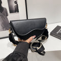 The Wave Silhouette Asymmetric Leather Saddle Bag