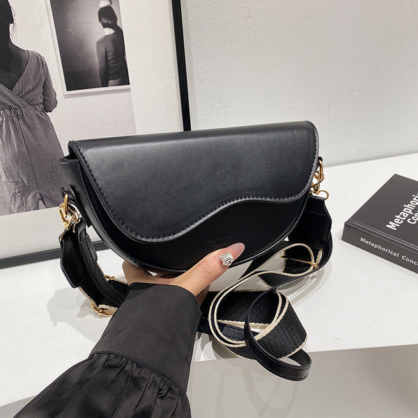 The Wave Silhouette Asymmetric Leather Saddle Bag