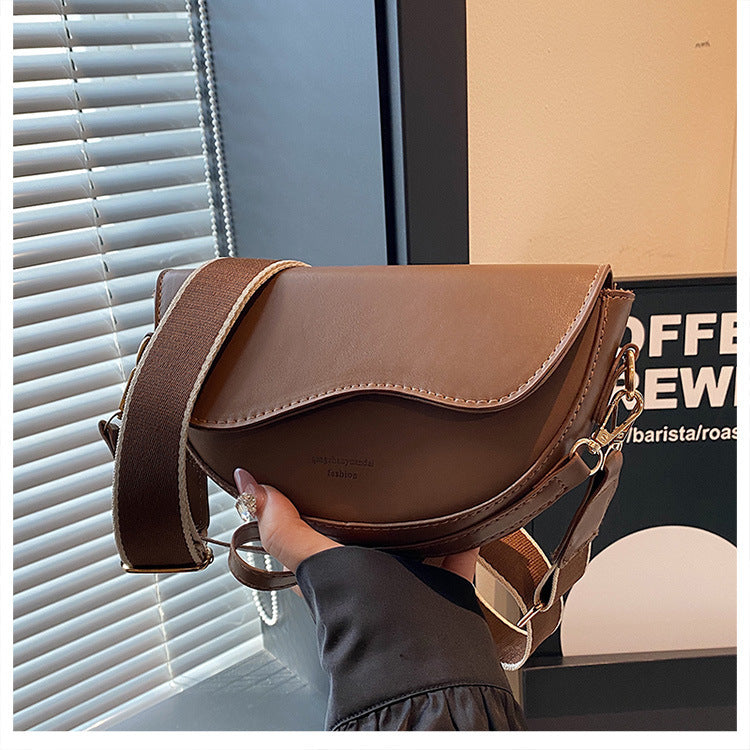 The Wave Silhouette Asymmetric Leather Saddle Bag