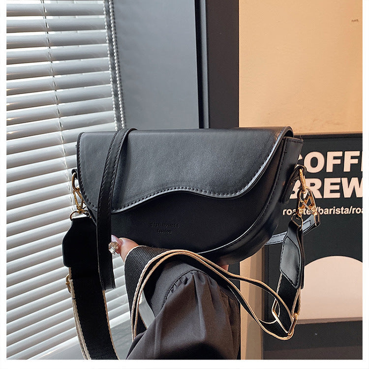 The Wave Silhouette Asymmetric Leather Saddle Bag